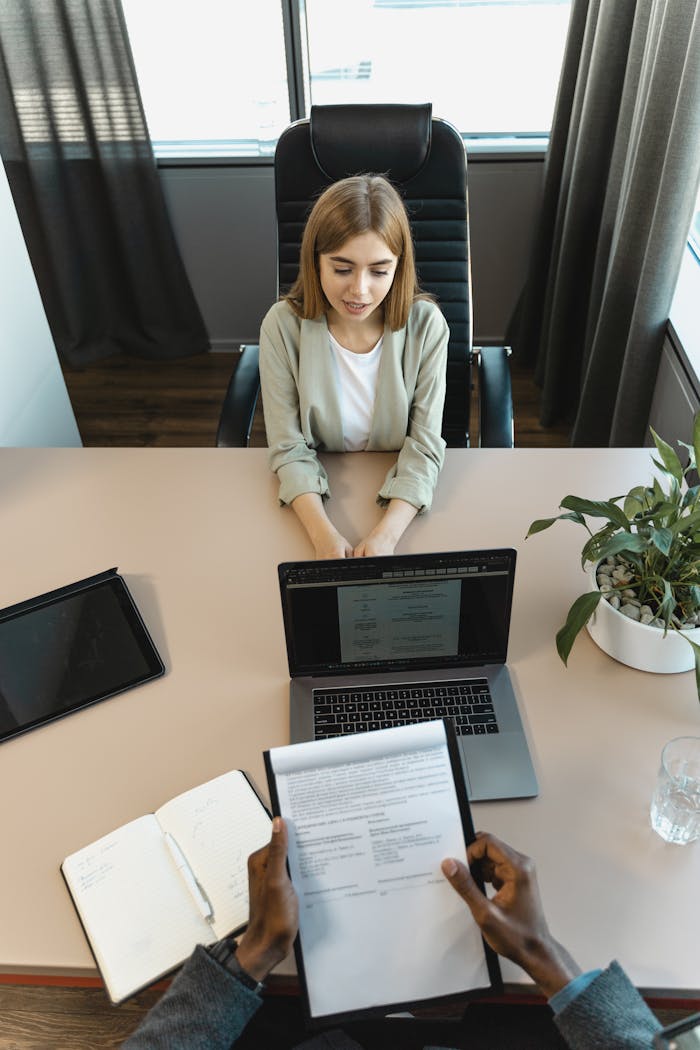 why-choose-us High-angle view of a job interview in a modern office setting, capturing professionalism.