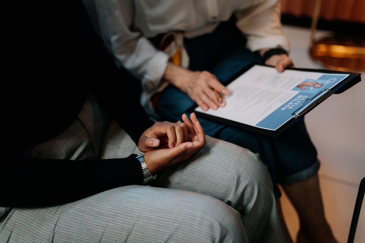 creative Two professionals reviewing a resume in an office setting, focused on teamwork.